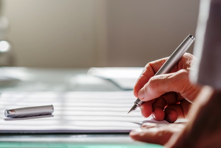 Businessman writing on a document