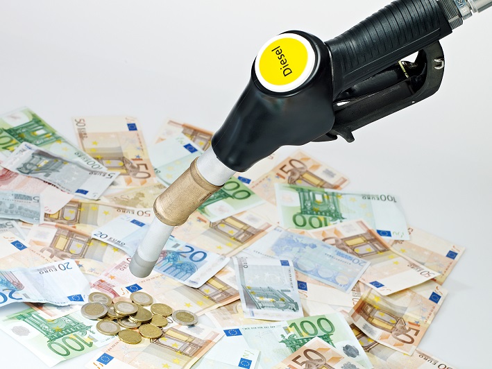 Fuel nozzle and a lot of money on white background