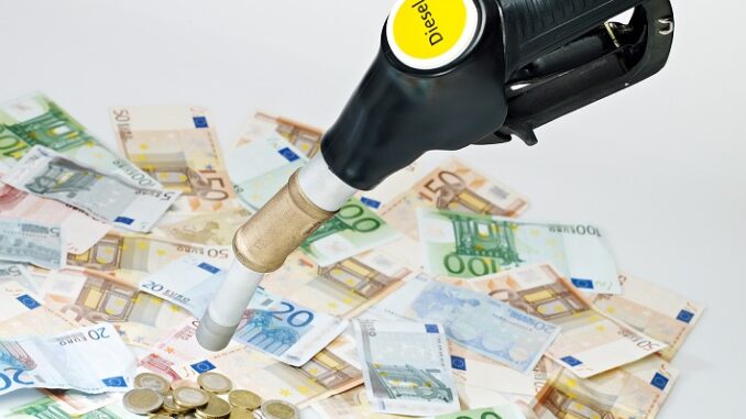 Fuel nozzle and a lot of money on white background