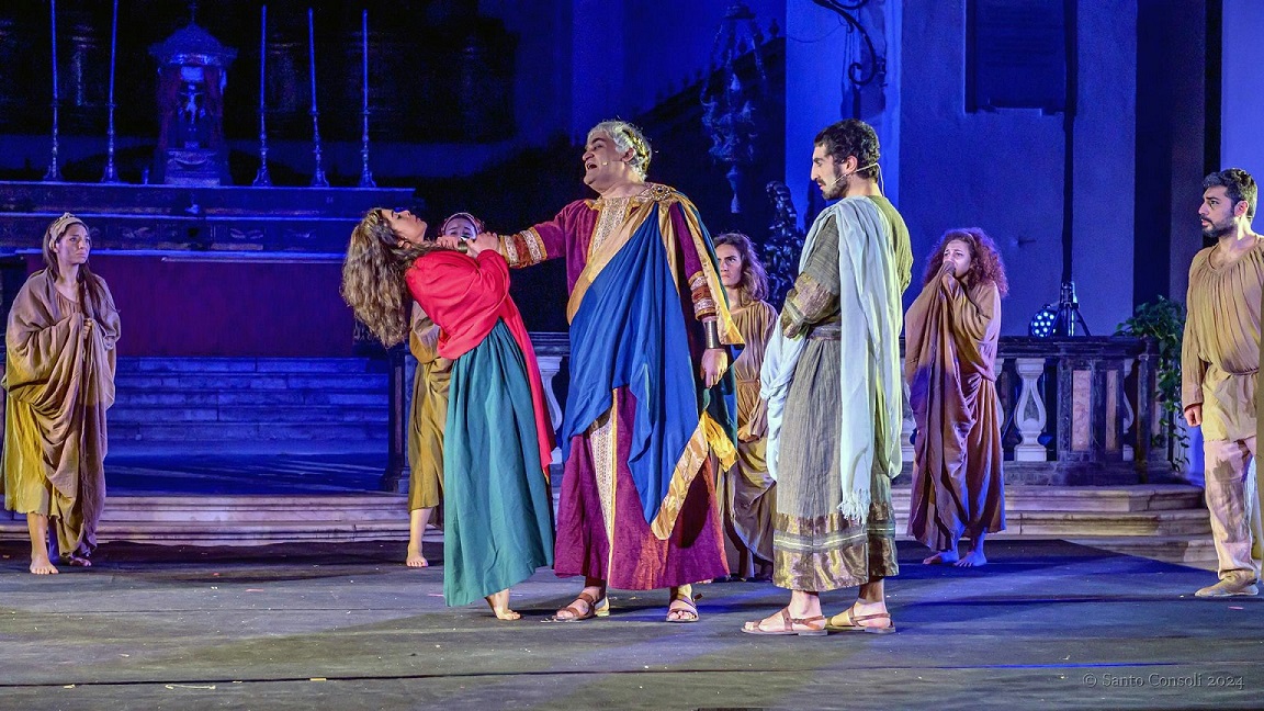 D – Davide Sbrogiò (Quinziano) con le mani sulla gola di Cecilia Guzzardi (Agata) e sullo sfondo il Coro. Ph. Santo Consoli (002)