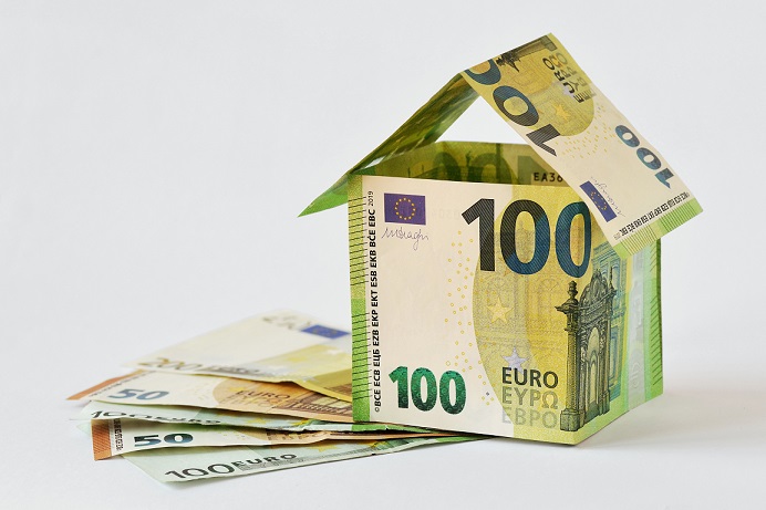 House made of euro banknotes on white background – Concept of bu