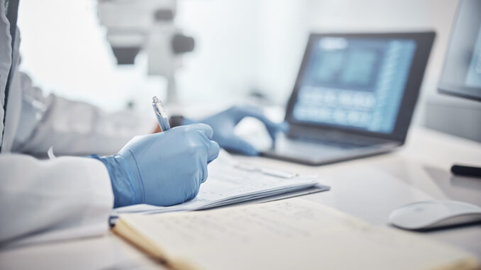Science, research and hands in lab with notebook and computer on scientific analysis. Experiment, internet and analytics, scientist in laboratory with data, vision and future in medical innovation.