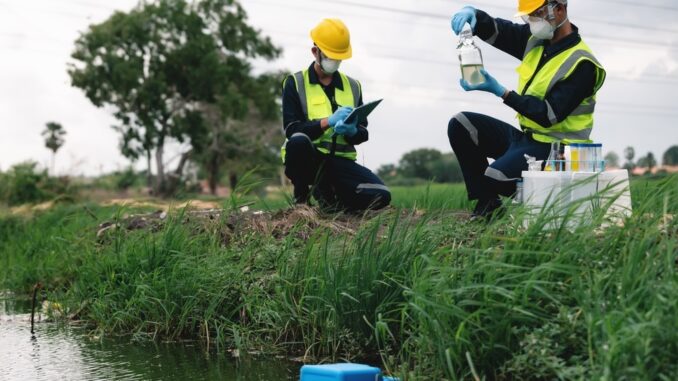Two,Environmental,Engineers,Inspect,Water,Quality,And,Take,Water,Samples